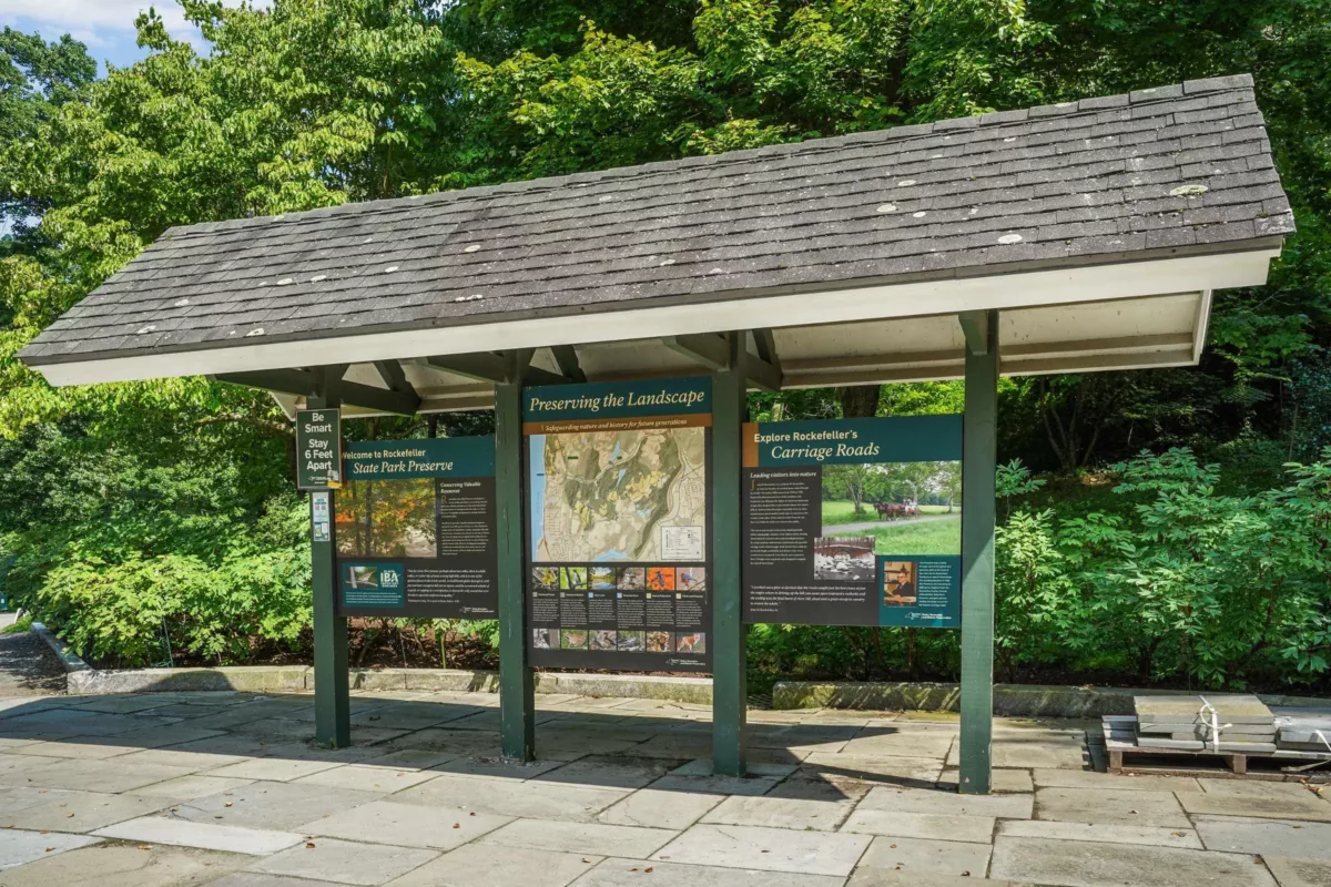 A shaded park shelter with park map display of The Rockefeller State Park Preserve.